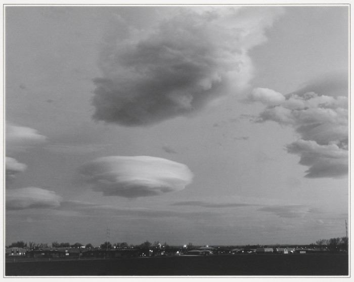 An ominous-looking whirly cloud forming over a town.