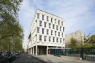 The Cité internationale des arts - a white boxy building on six stories, Parisian style, surrounded by trees and a neat lawn.