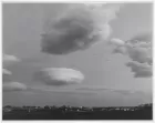 An ominous-looking whirly cloud forming over a town.