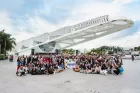 Huge conference group pic on the concrete outside a stylish conference centre.