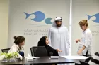 Participants of SAWA Museum Academy debate at a conference table.