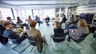 A circle of seated dance critics at the Springback Academy.