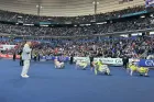 A group of young Welsh dancers perform to a packed crowd in a French sports stadium.